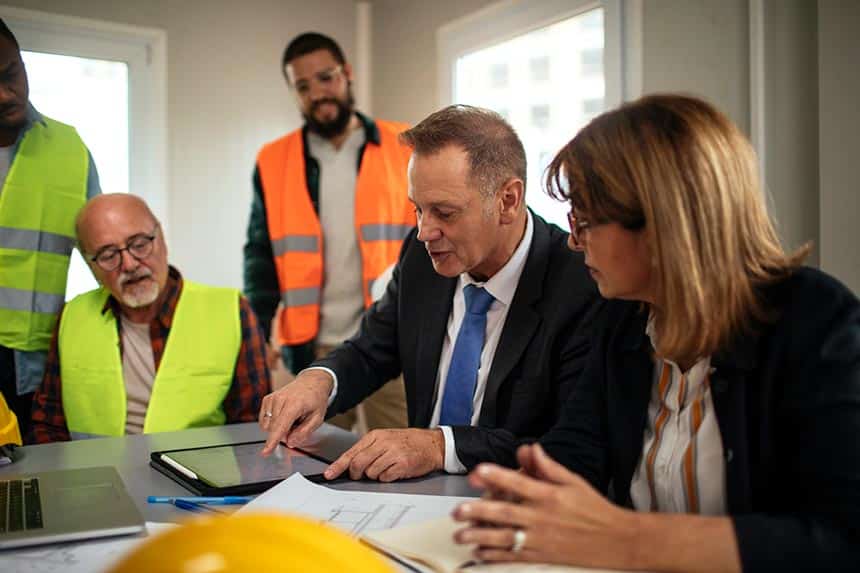 Board directors having a meeting with the team in the office at the construction site